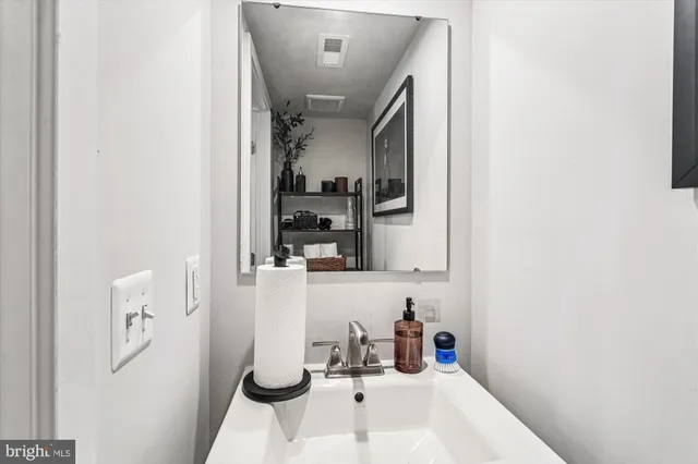 a bathroom with a sink and mirror