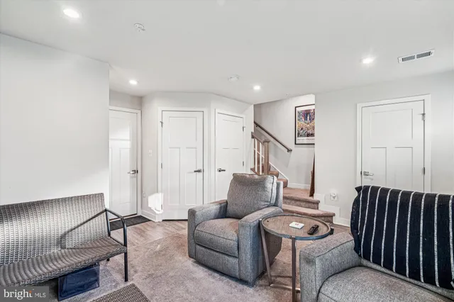 a living room with furniture and a ceiling fan