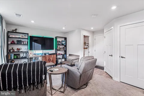 a living room with lots of furniture and a flat screen tv