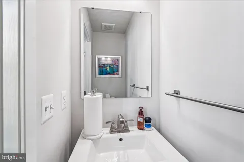 a bathroom with a sink a mirror and a toilet