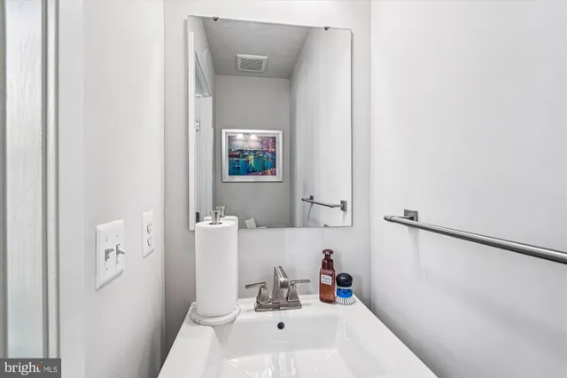 a bathroom with a sink a mirror and a toilet