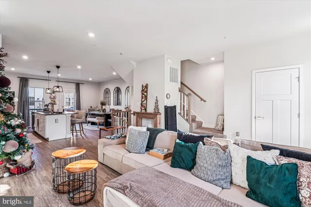 a living room with furniture and a view of kitchen