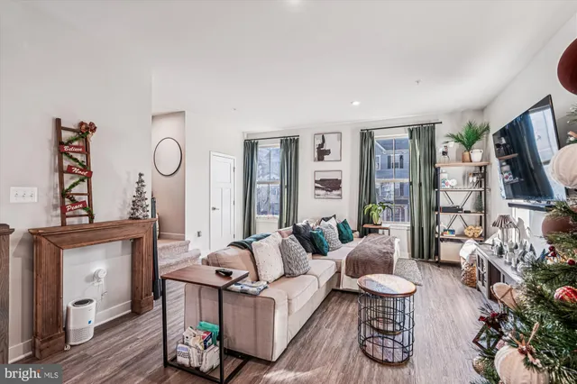 a living room with furniture a rug and a flat screen tv