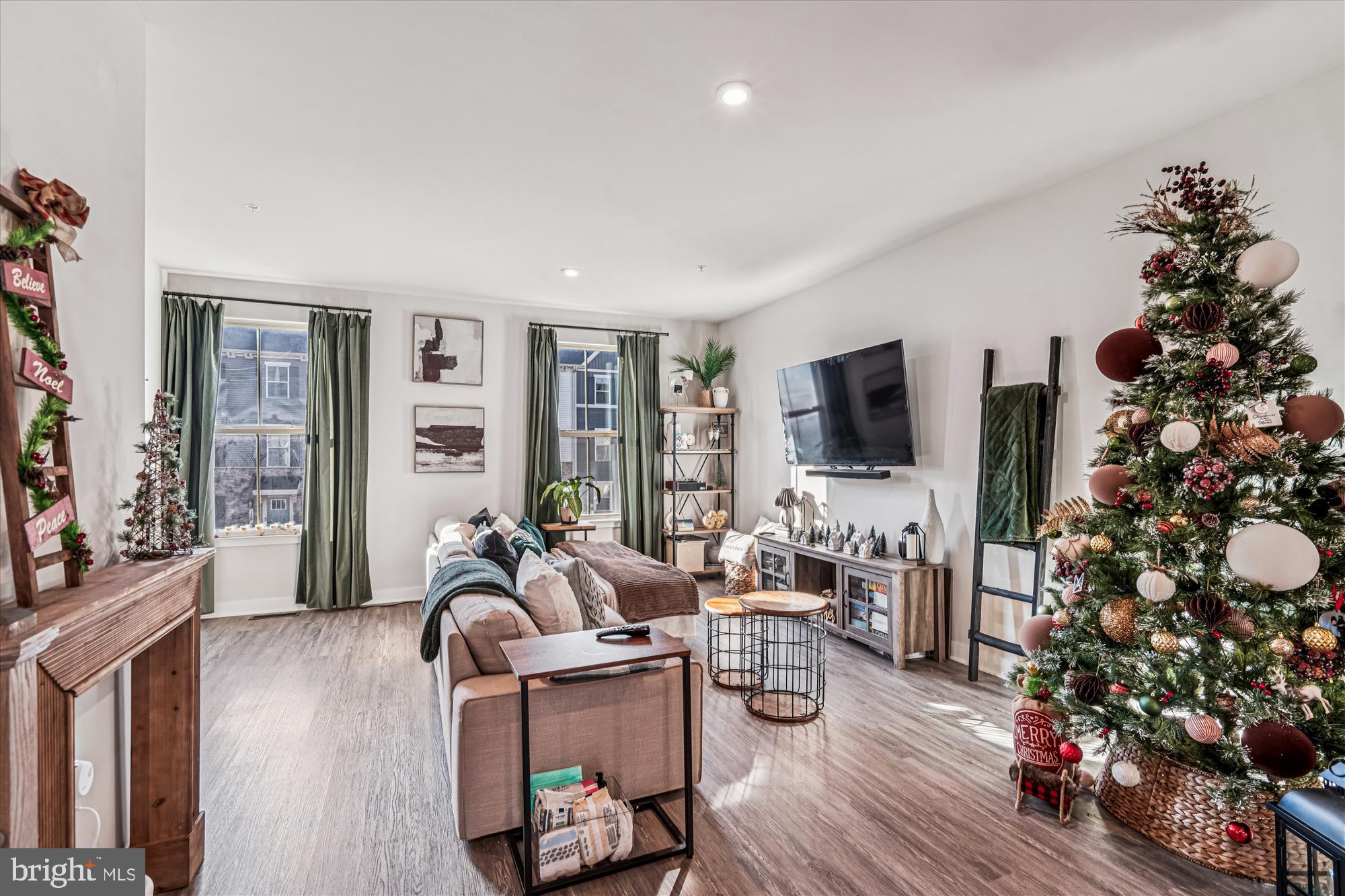 136 Brown Branch Road Laurel, MD 20708 - Photo 6 of 44 a living room with furniture a flat screen tv and a fireplace