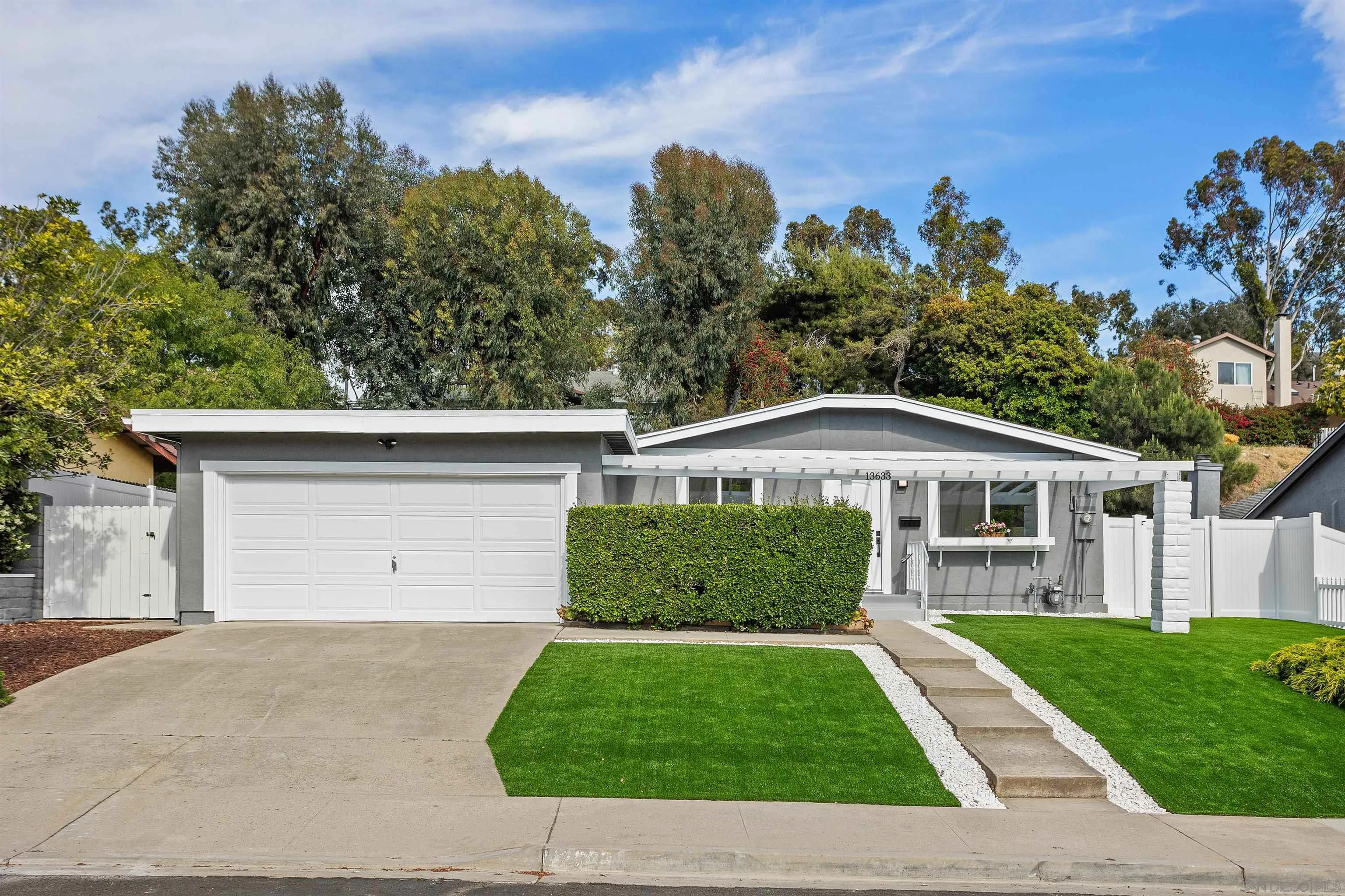 13633 Carriage Road Poway, CA 92064 - Photo 1 of 1 a front view of a house with a yard and garage