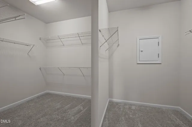 a spacious bathroom with a granite countertop sink a mirror and a shower