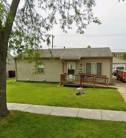 a view of a house with a yard and sitting area
