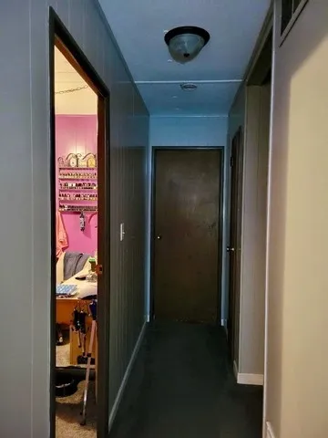 a view of a hallway view with wooden floor and workspace