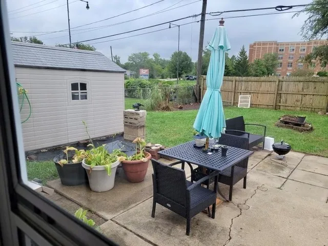 a view of a chairs and table in backyard of the house
