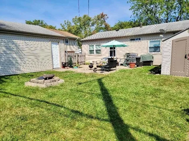 a front view of house with yard outdoor seating and green space