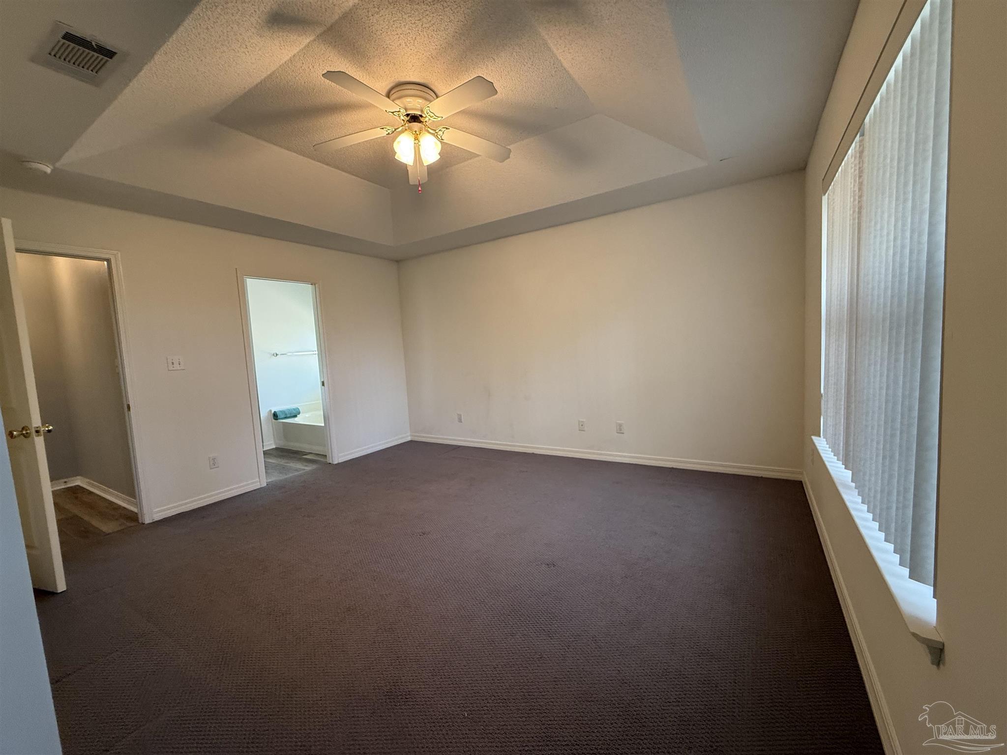 5700 Charmonte Way Milton, FL 32583 - Photo 16 of 29 wooden floor in an empty room with a window