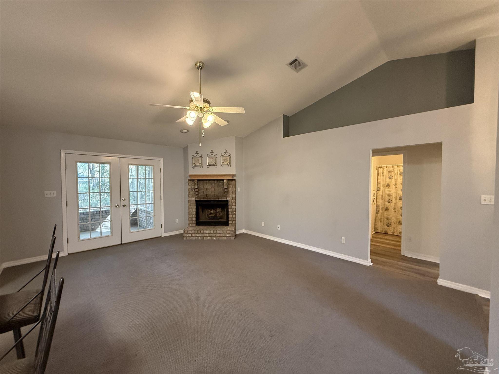 5700 Charmonte Way Milton, FL 32583 - Photo 17 of 29 an empty room with windows and fireplace