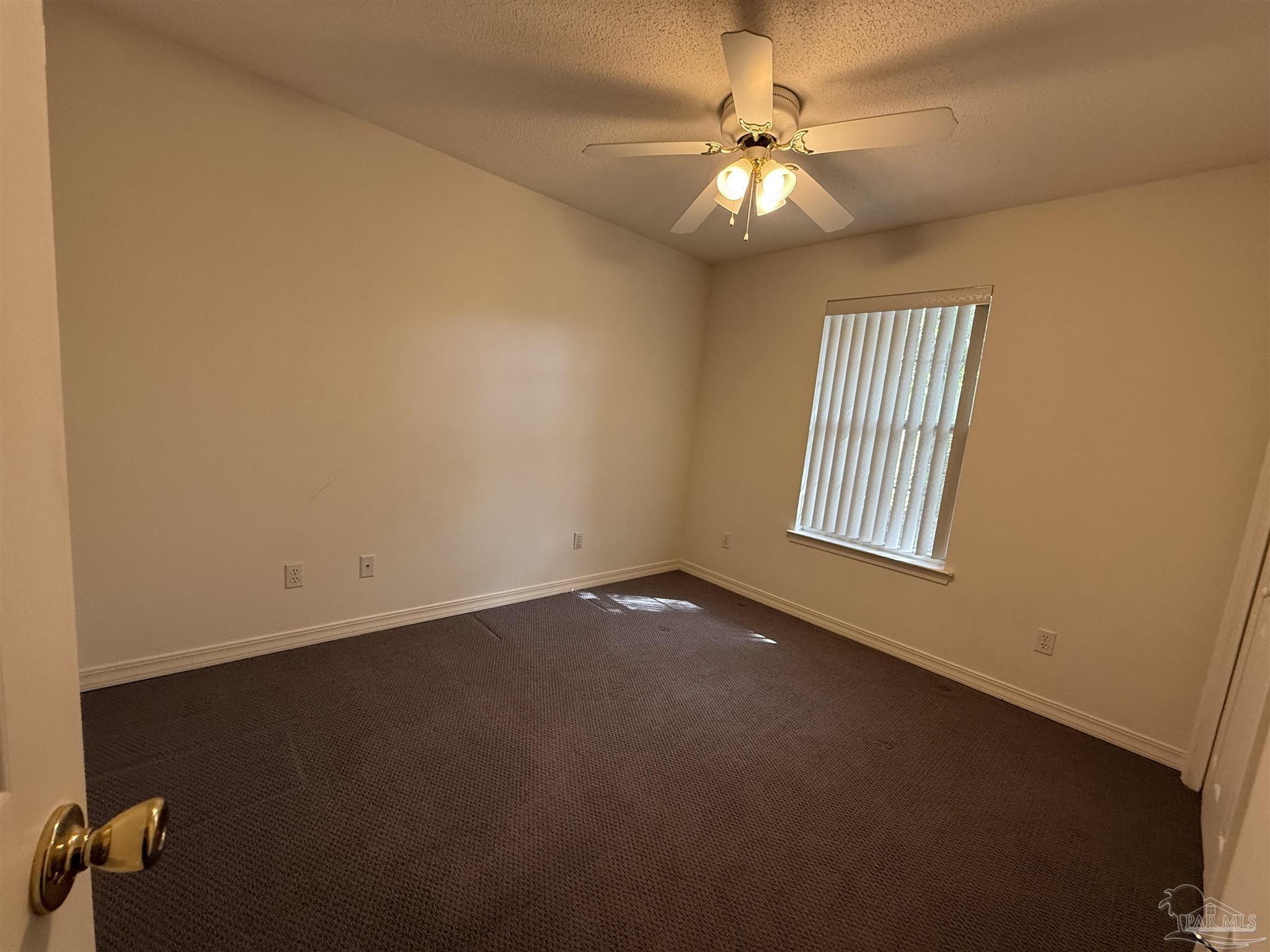 5700 Charmonte Way Milton, FL 32583 - Photo 18 of 29 an empty room with windows and fan