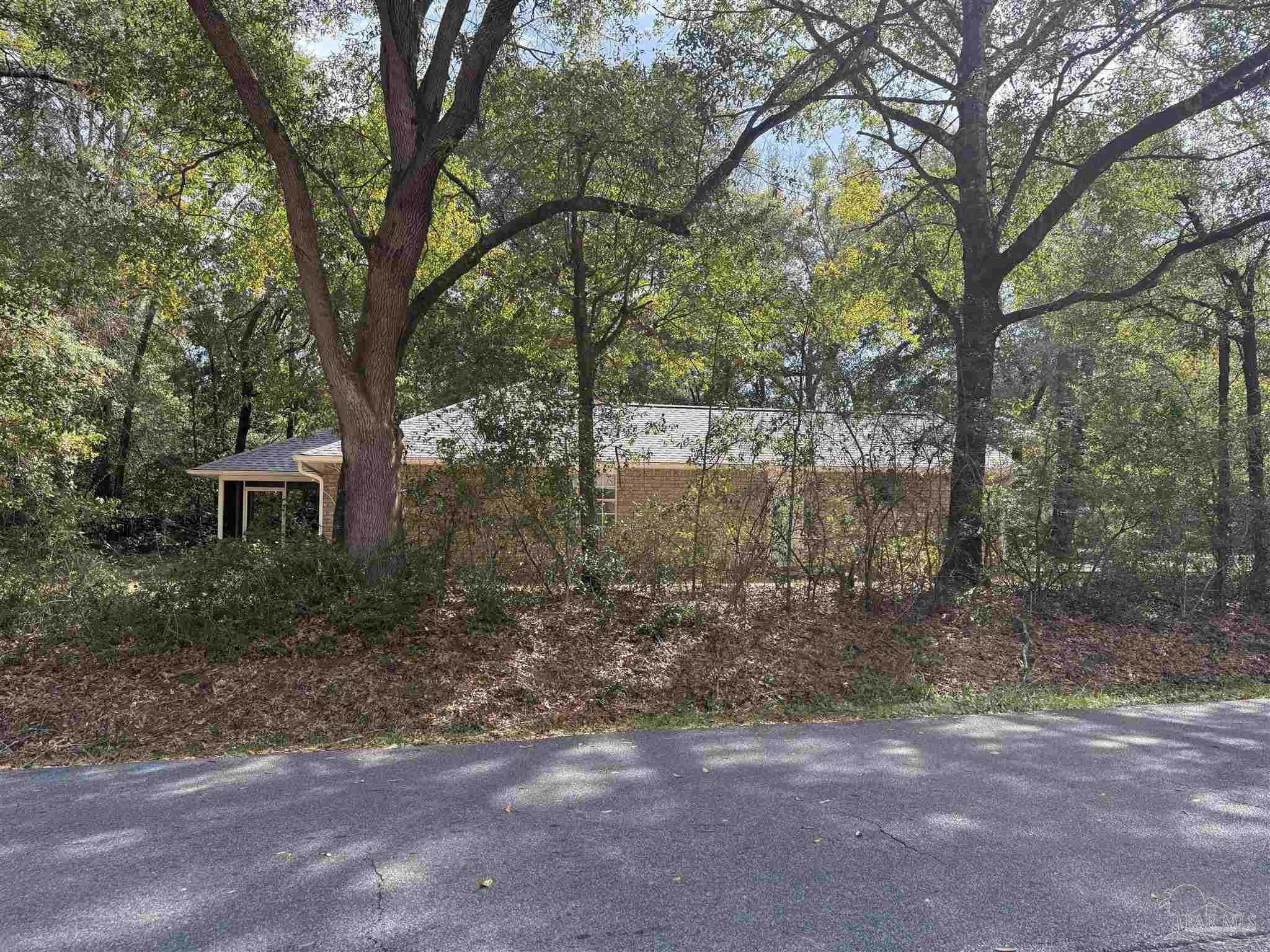 5700 Charmonte Way Milton, FL 32583 - Photo 2 of 29 a backyard of a house with lots of green space