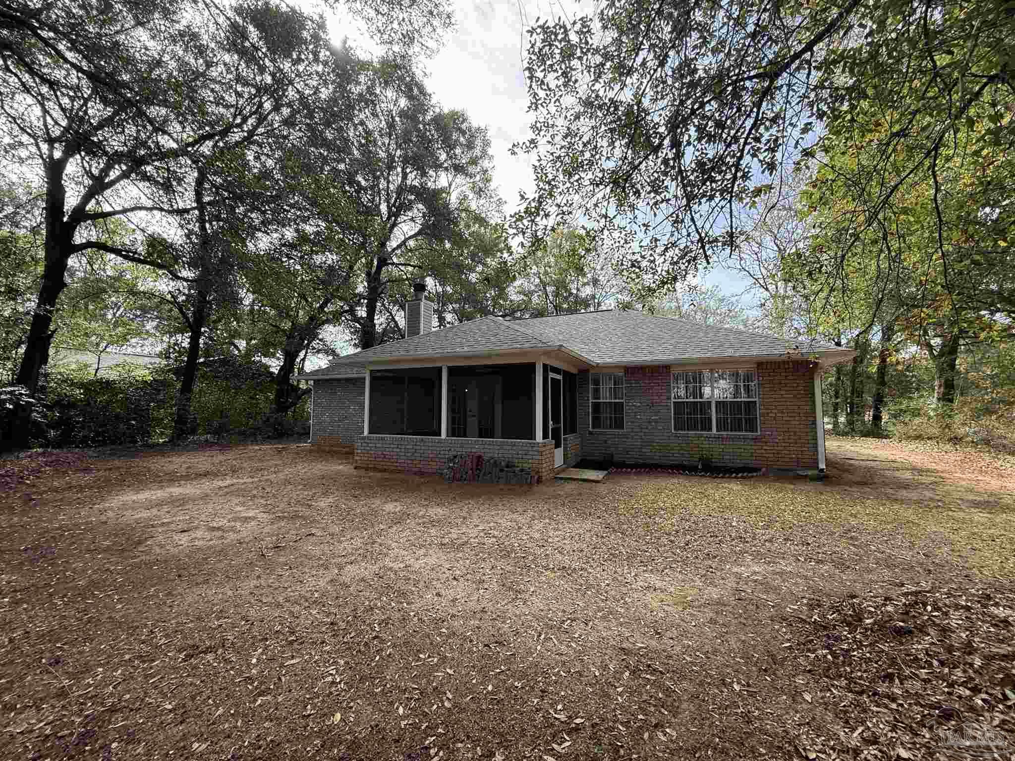 5700 Charmonte Way Milton, FL 32583 - Photo 21 of 29 a front view of a house with a garden