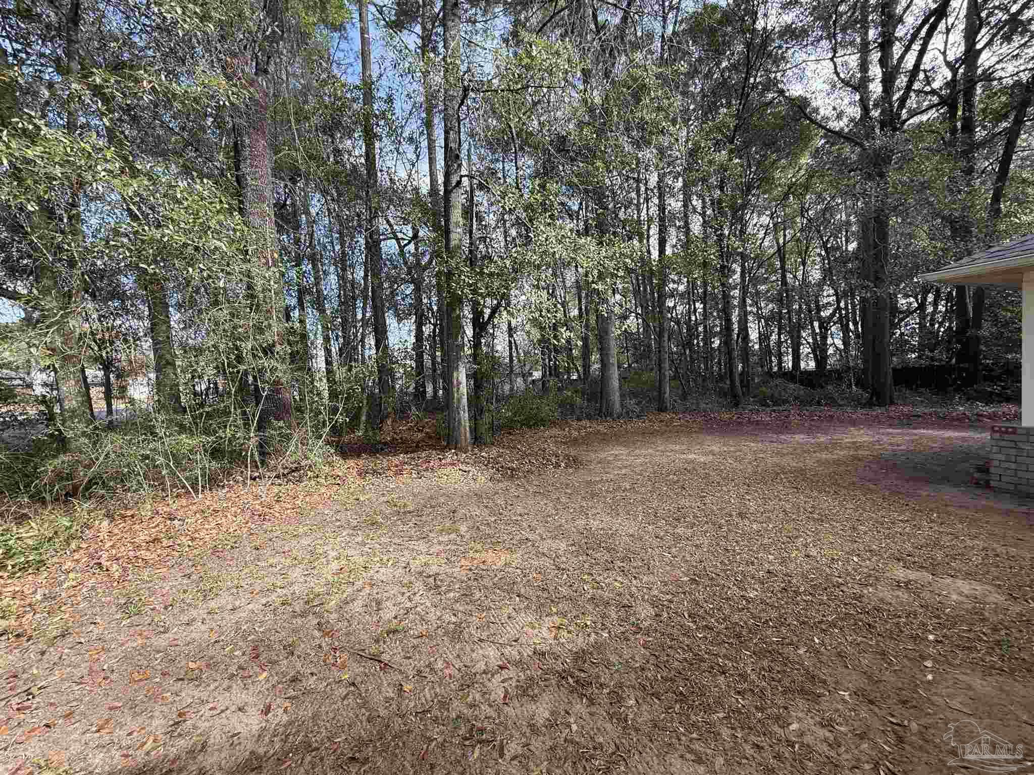 5700 Charmonte Way Milton, FL 32583 - Photo 22 of 29 a backyard of a house with lots of green space