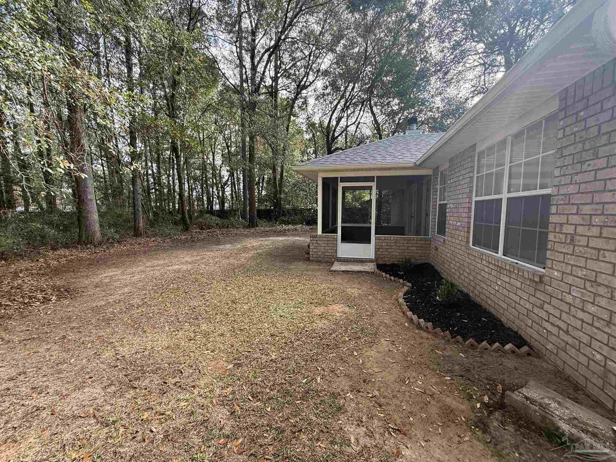 5700 Charmonte Way Milton, FL 32583 - Photo 23 of 29 a view of a house with backyard and a tree