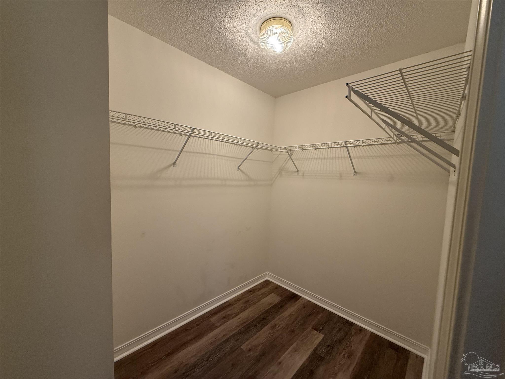 5700 Charmonte Way Milton, FL 32583 - Photo 25 of 29 a view of a room with racks on the wall