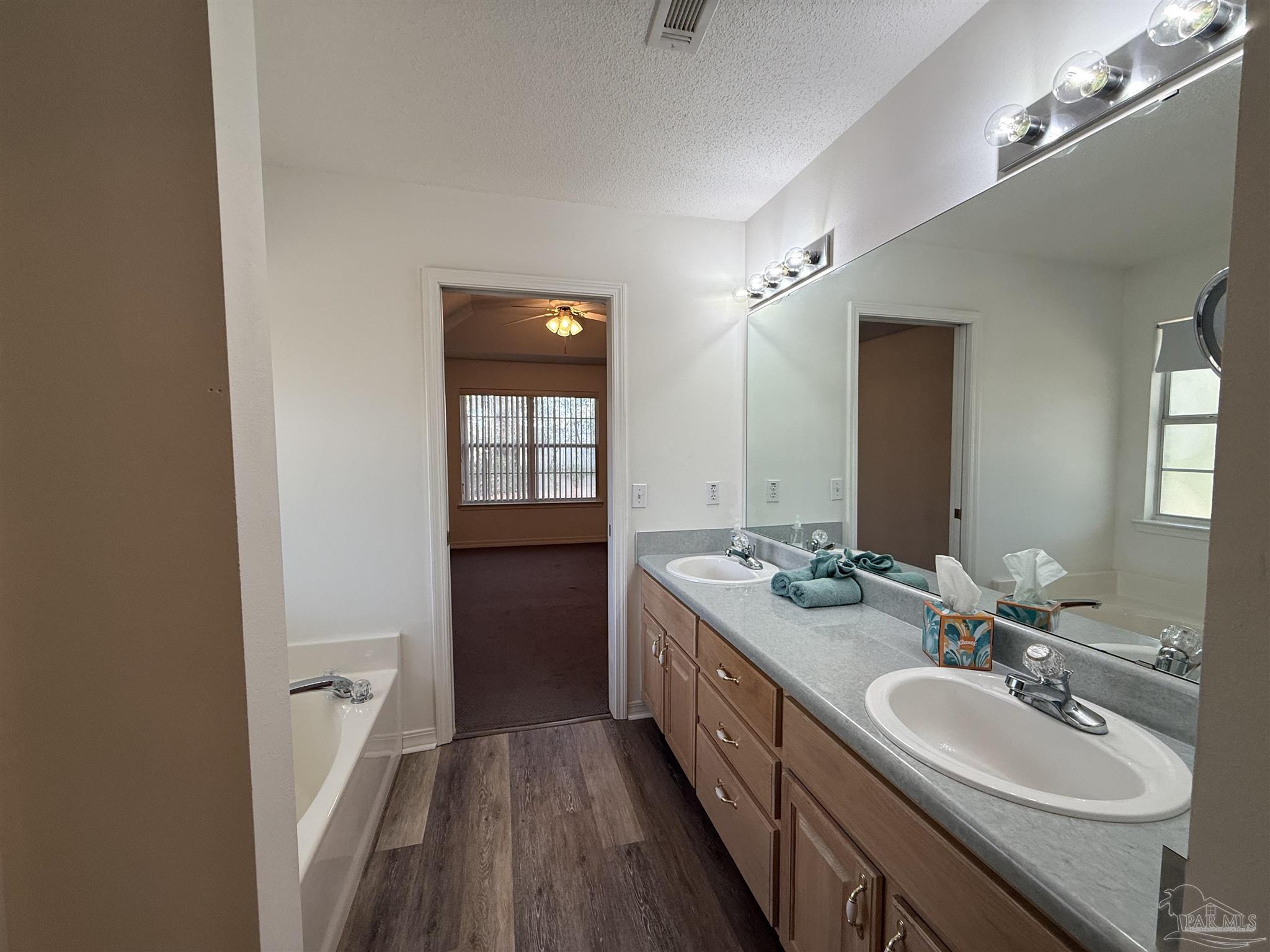 5700 Charmonte Way Milton, FL 32583 - Photo 27 of 29 a bathroom with a double vanity sink and a mirror