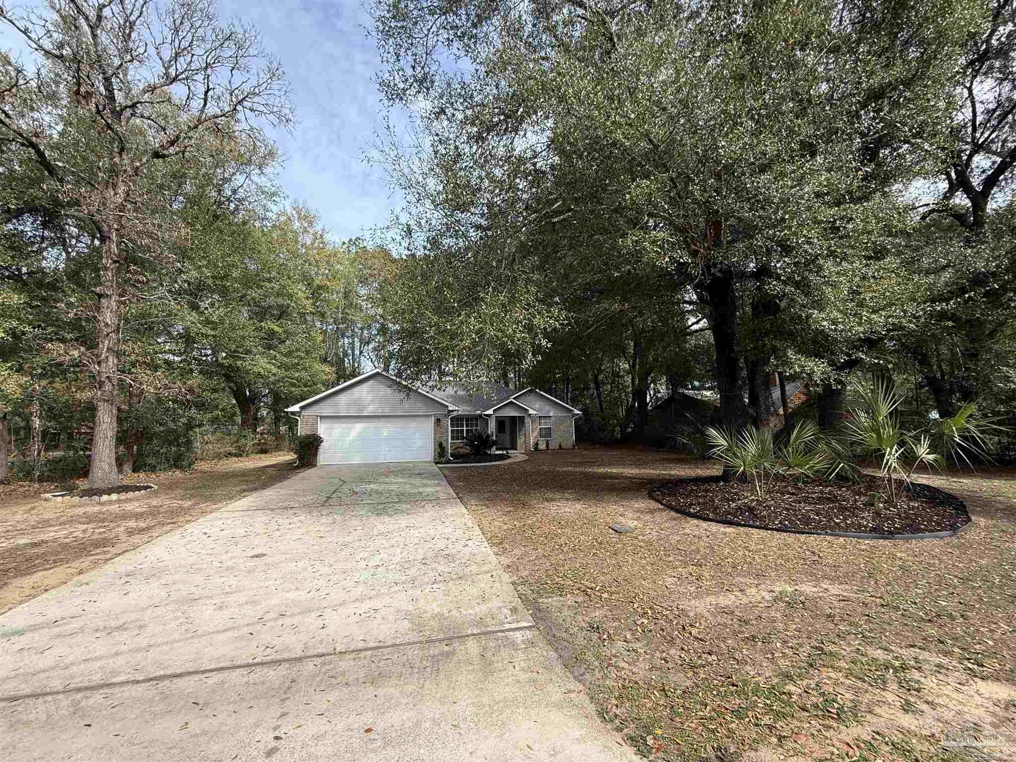 5700 Charmonte Way Milton, FL 32583 - Photo 4 of 29 a front view of a house with a yard