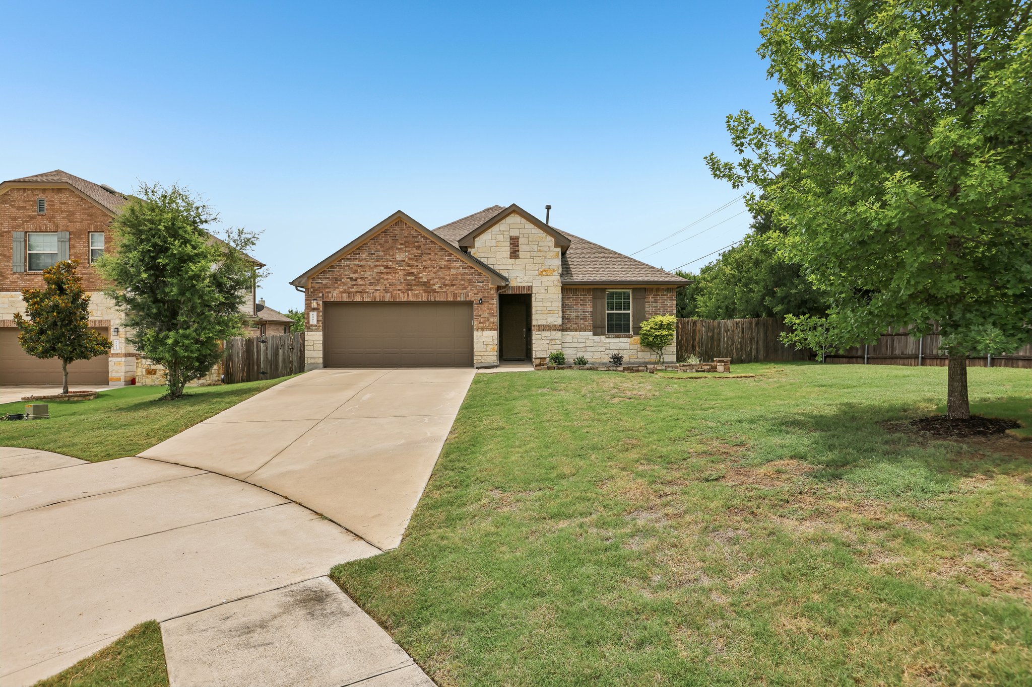 6801 Banff Cove Austin, TX 78754 - Photo 3 of 37 A well-maintained lawn and extended concrete driveway leading to 2 car garage