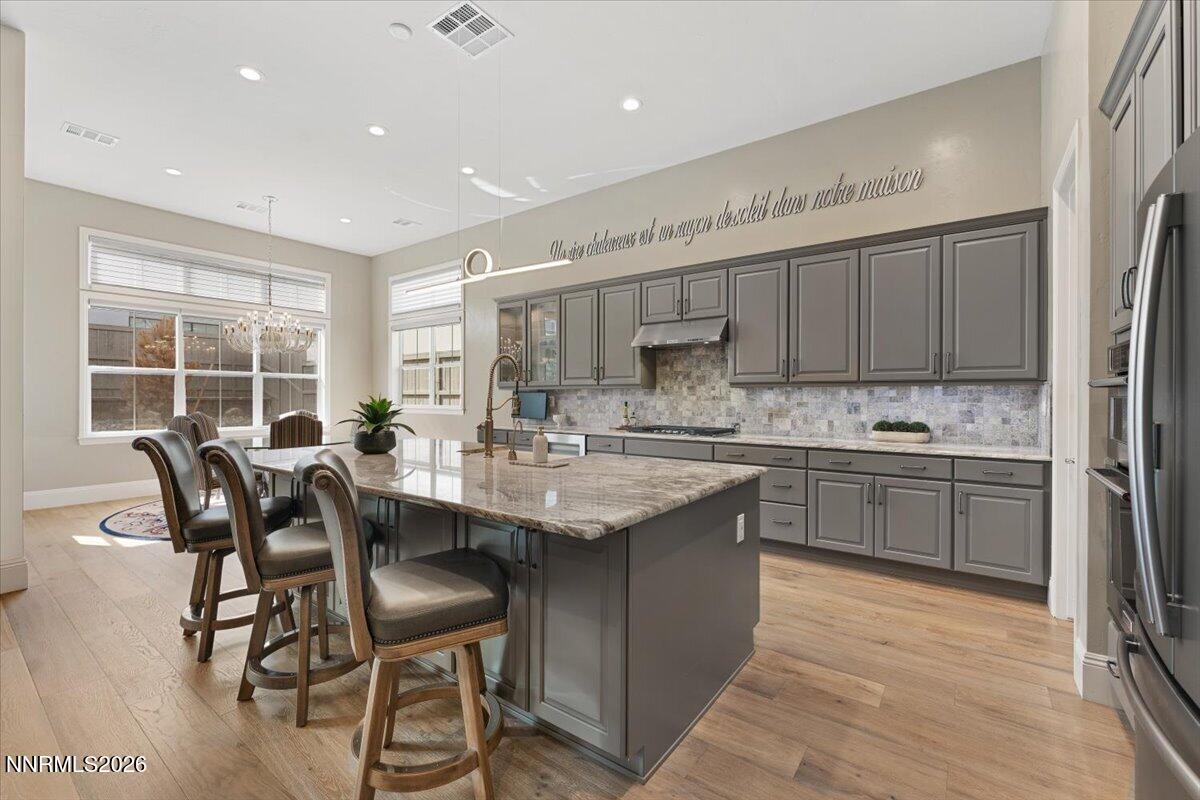 722 West Pleasant Oak Trail Reno, NV 89511 - Photo 12 of 98 a kitchen with stainless steel appliances granite countertop a table chairs sink refrigerator and cabinets