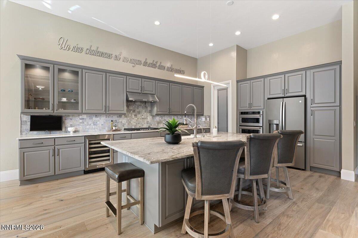 722 West Pleasant Oak Trail Reno, NV 89511 - Photo 14 of 98 a kitchen with stainless steel appliances kitchen island granite countertop a refrigerator and a stove top oven