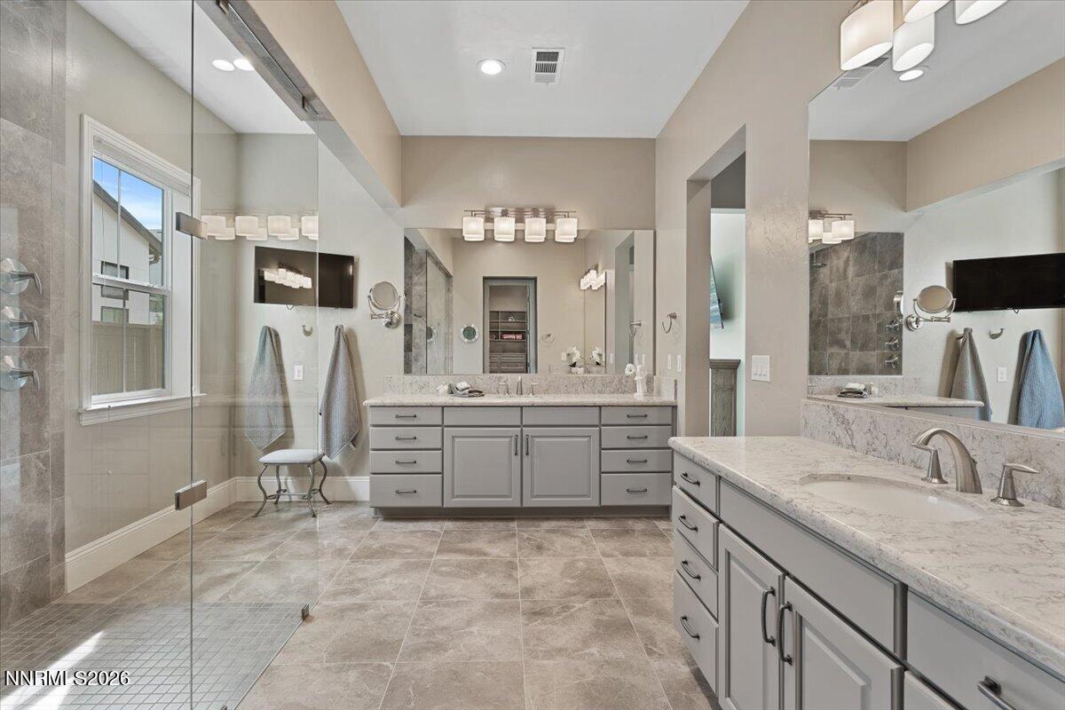 722 West Pleasant Oak Trail Reno, NV 89511 - Photo 25 of 98 a spacious bathroom with a granite countertop sink a mirror a bathtub and a shower