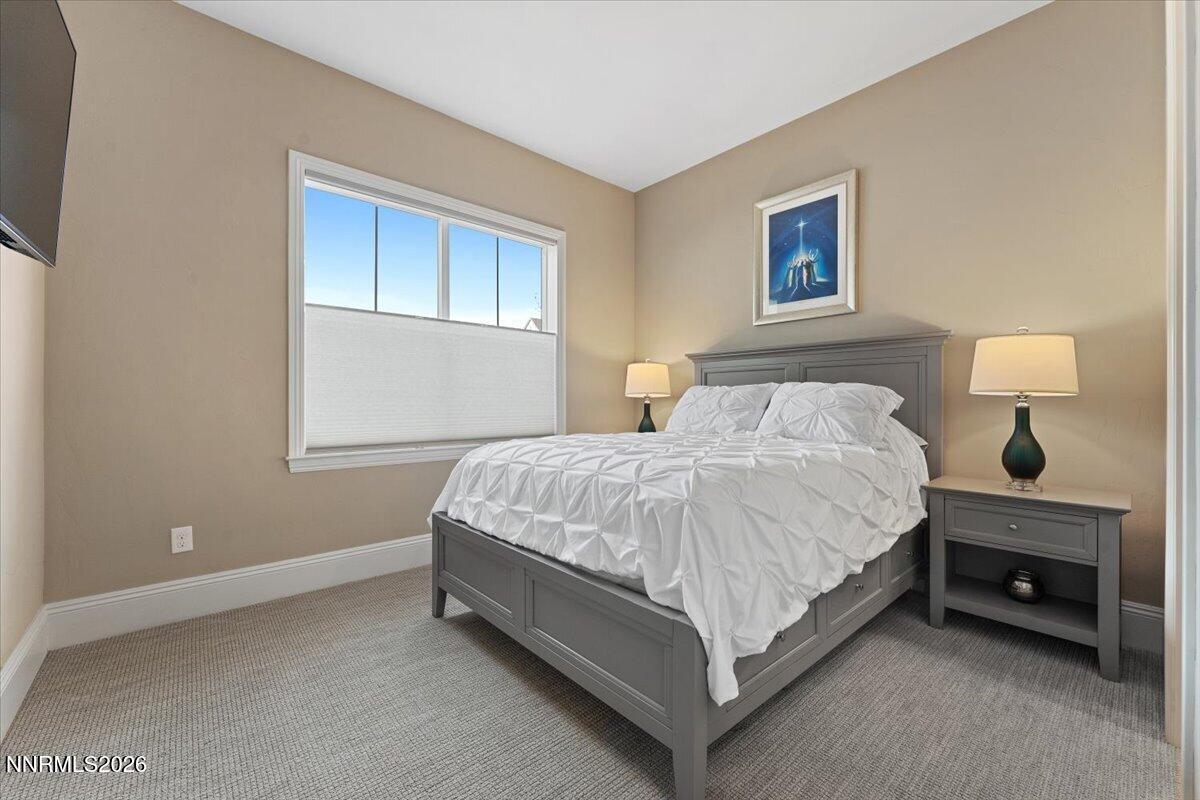 722 West Pleasant Oak Trail Reno, NV 89511 - Photo 27 of 98 a bed sitting in a bedroom next to a lamp