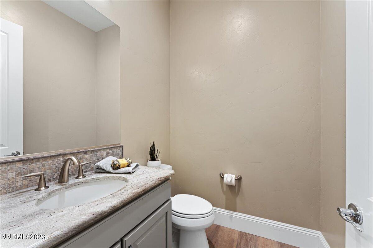 722 West Pleasant Oak Trail Reno, NV 89511 - Photo 33 of 98 a bathroom with a granite countertop sink a toilet and a mirror