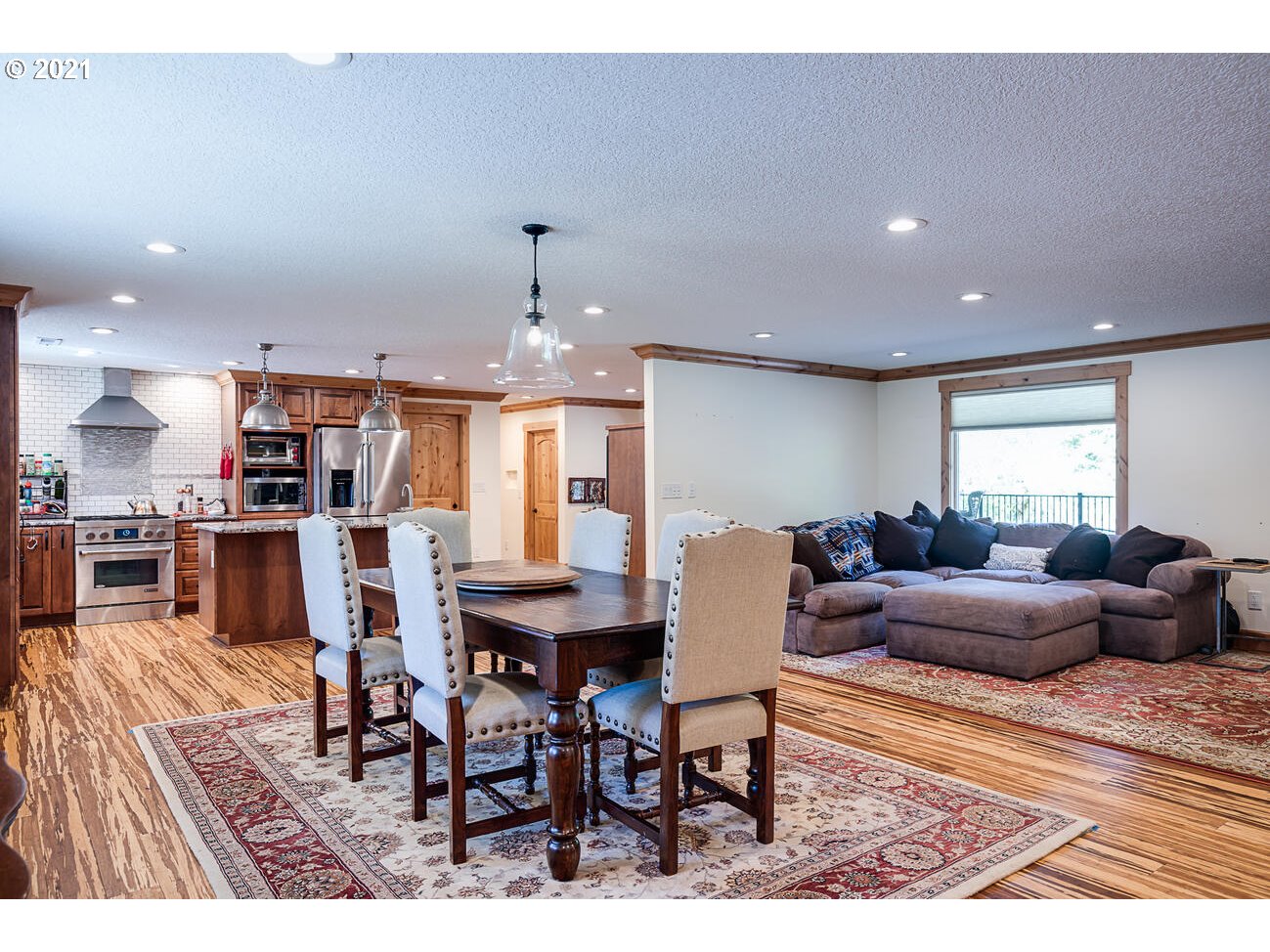 22255 Southeast Ridgeview Drive Damascus, OR 97089 - Photo 3 of 32 a living room with furniture a dining table and kitchen view
