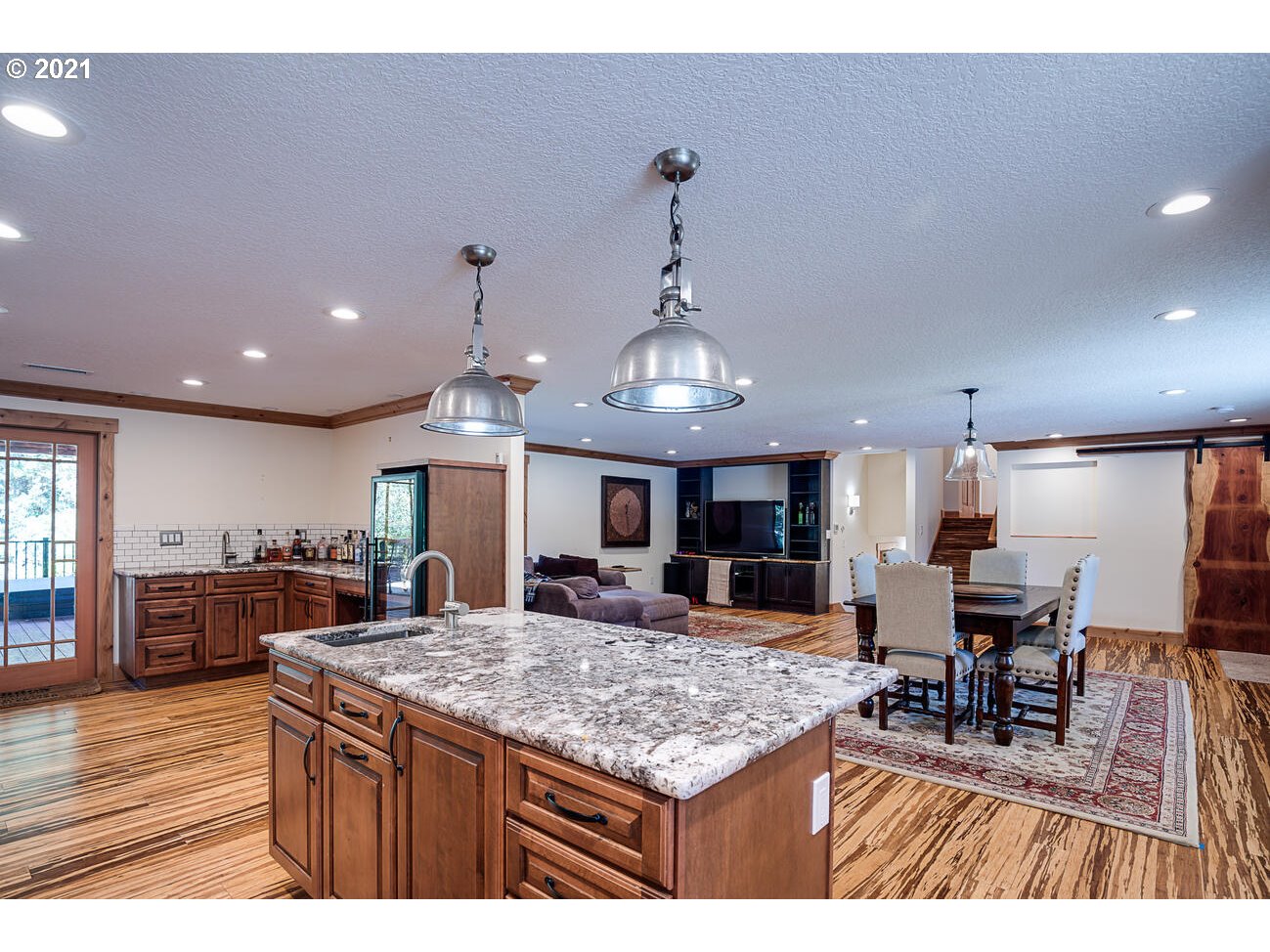 22255 Southeast Ridgeview Drive Damascus, OR 97089 - Photo 8 of 32 a kitchen with kitchen island a large counter top furniture and appliances