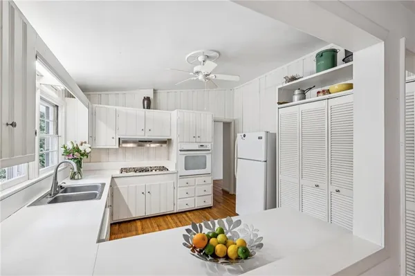 a kitchen with stainless steel appliances a refrigerator sink and cabinets