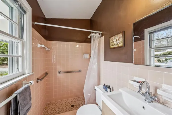 a bathroom with a sink toilet and shower