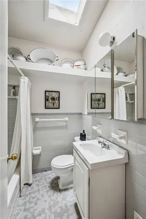 a bathroom with a sink mirror vanity and toilet