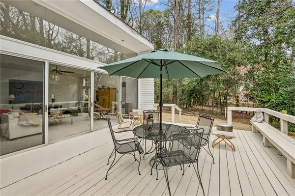 a view of a patio with a table and chairs under an umbrella