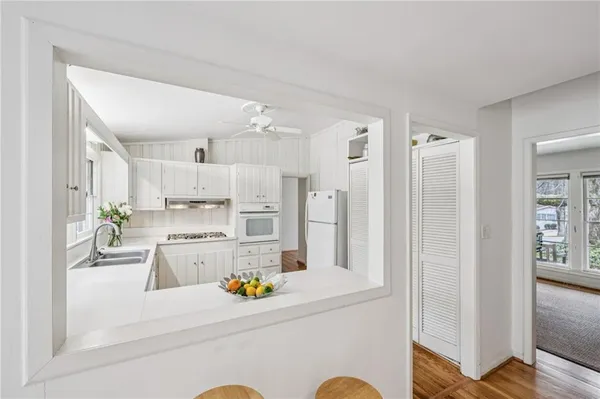 a kitchen with stainless steel appliances a refrigerator and a cabinets