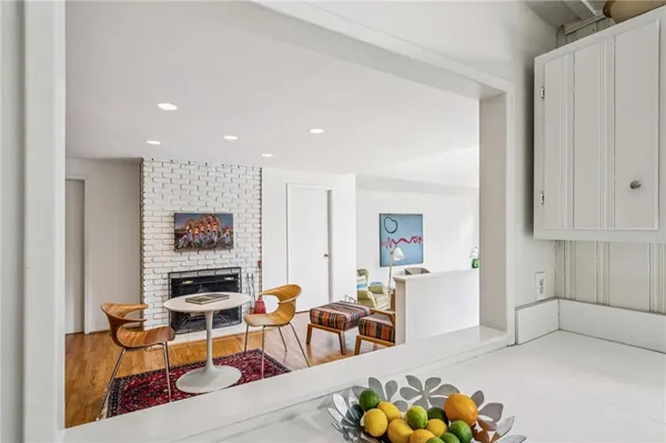 a living room with furniture and a kitchen
