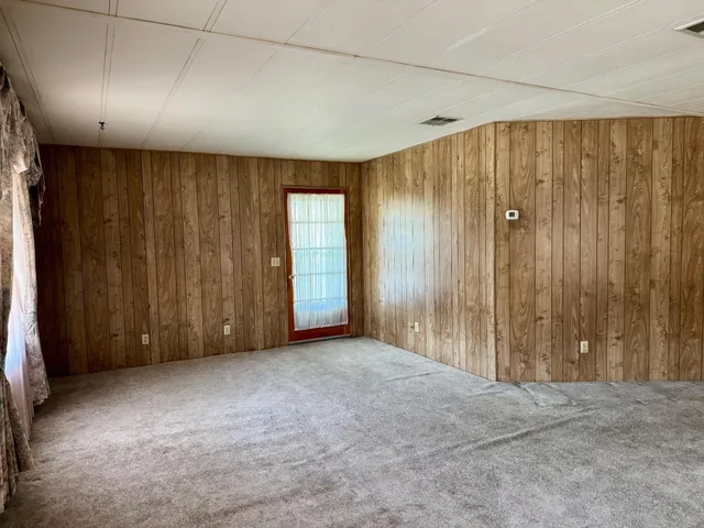 a view of an empty room with wooden walls