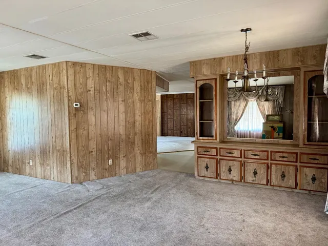 a view of a big room with chandelier windows and cabinet