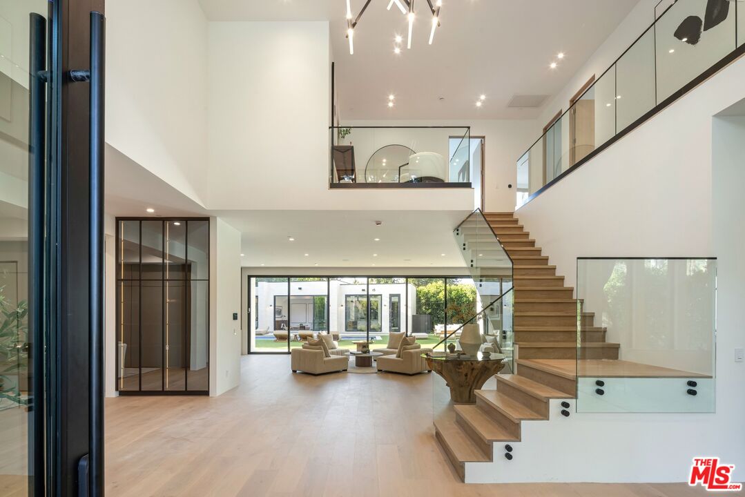 17055 Rancho Street Encino, CA 91316 - Photo 17 of 73 a living room with furniture and a large window