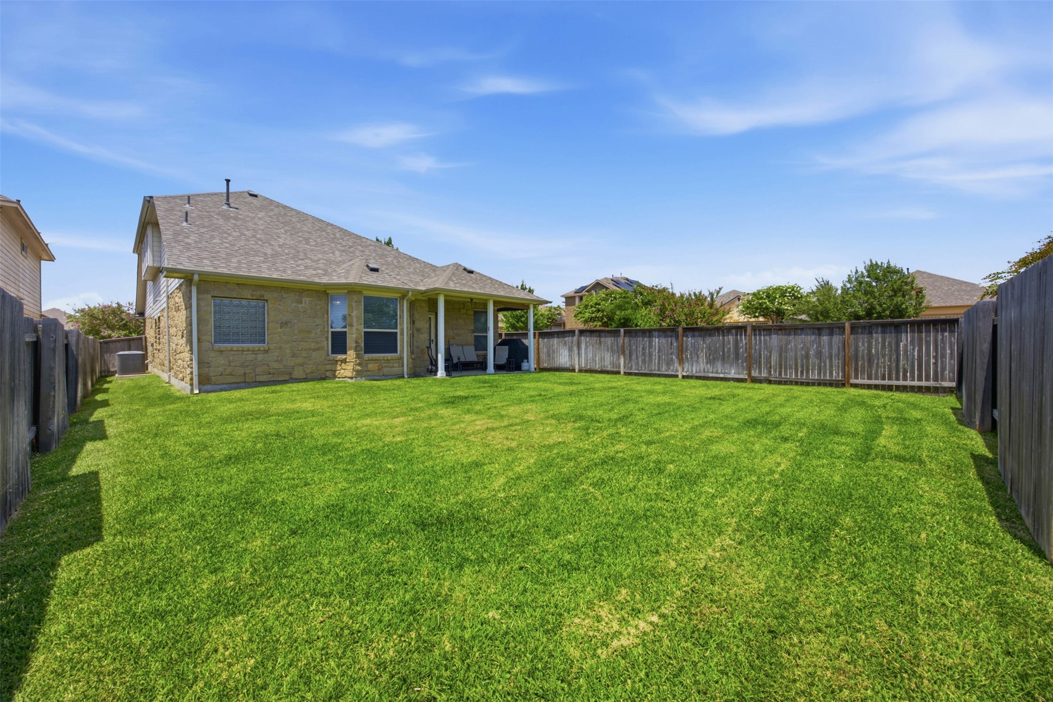 328 Rock Mill Loop Georgetown, TX 78626 - Photo 28 of 29 A private, fenced backyard provides a clean, open space perfect for gatherings or relaxing evenings outside. The green lawn offers flexibility for gardening, play, or future landscaping. It is an inviting extension of the home's living space.