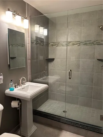 a bathroom with a sink mirror and toilet