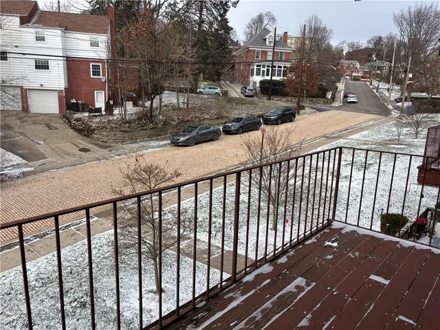 a view of a balcony with wooden fence