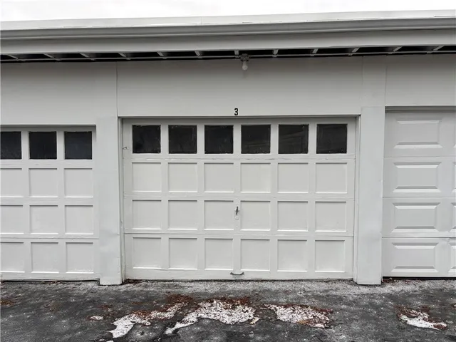 a front view of a house with a large tree