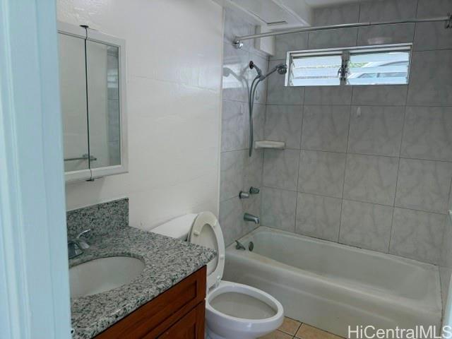 1565 Moani Street Honolulu, HI 96819 - Photo 12 of 22 a bathroom with a granite countertop sink a toilet and bathtub