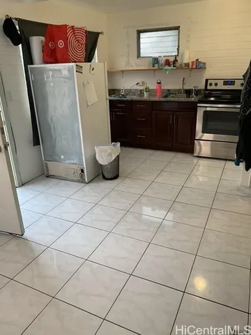 a kitchen with a sink and a refrigerator