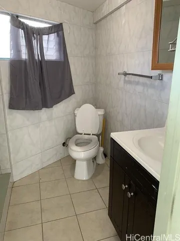 a white toilet sitting next to a shower