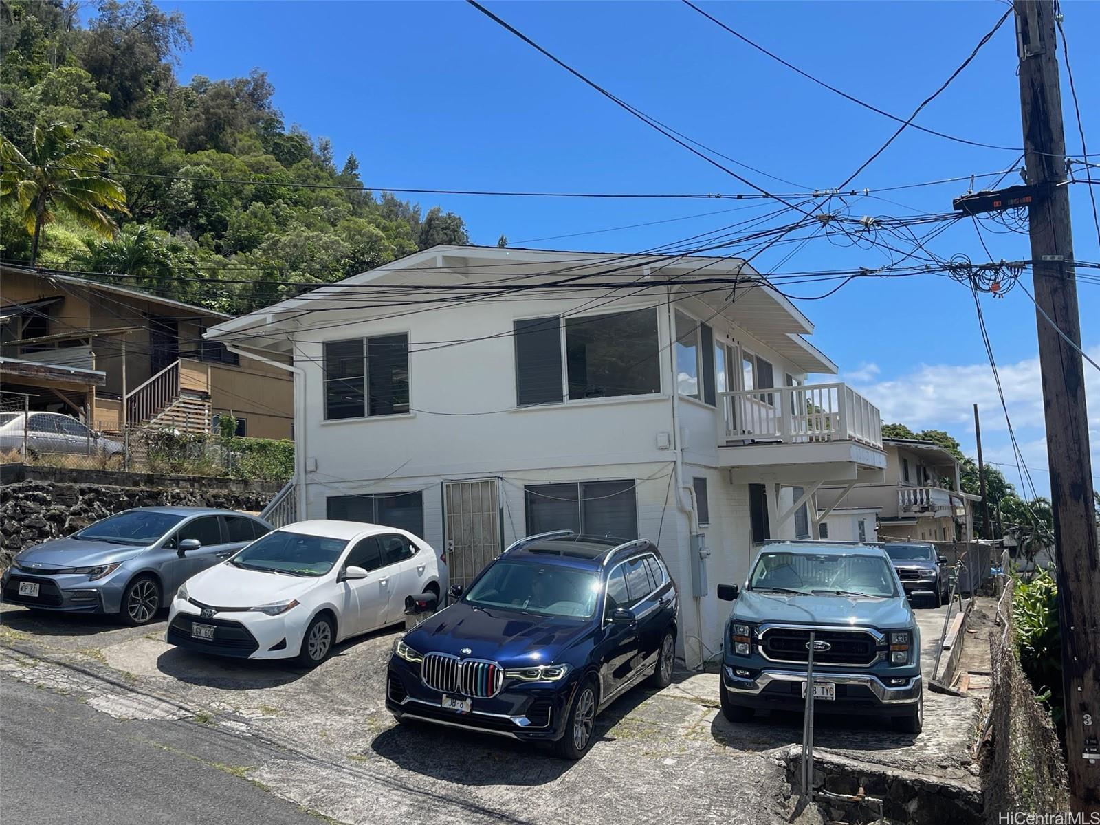 1565 Moani Street Honolulu, HI 96819 - Photo 2 of 22 a car parked in front of a house