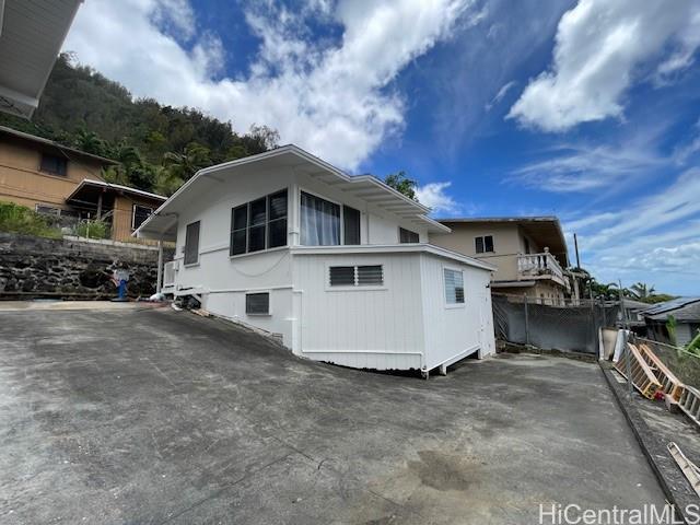 1565 Moani Street Honolulu, HI 96819 - Photo 3 of 22 a view of a house with a yard and sitting area